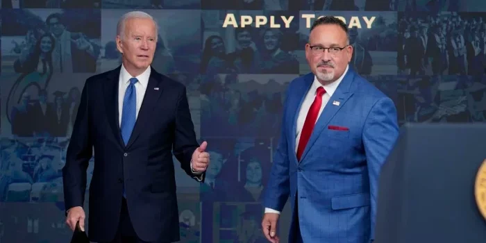 Joe Biden and Miguel Cardona